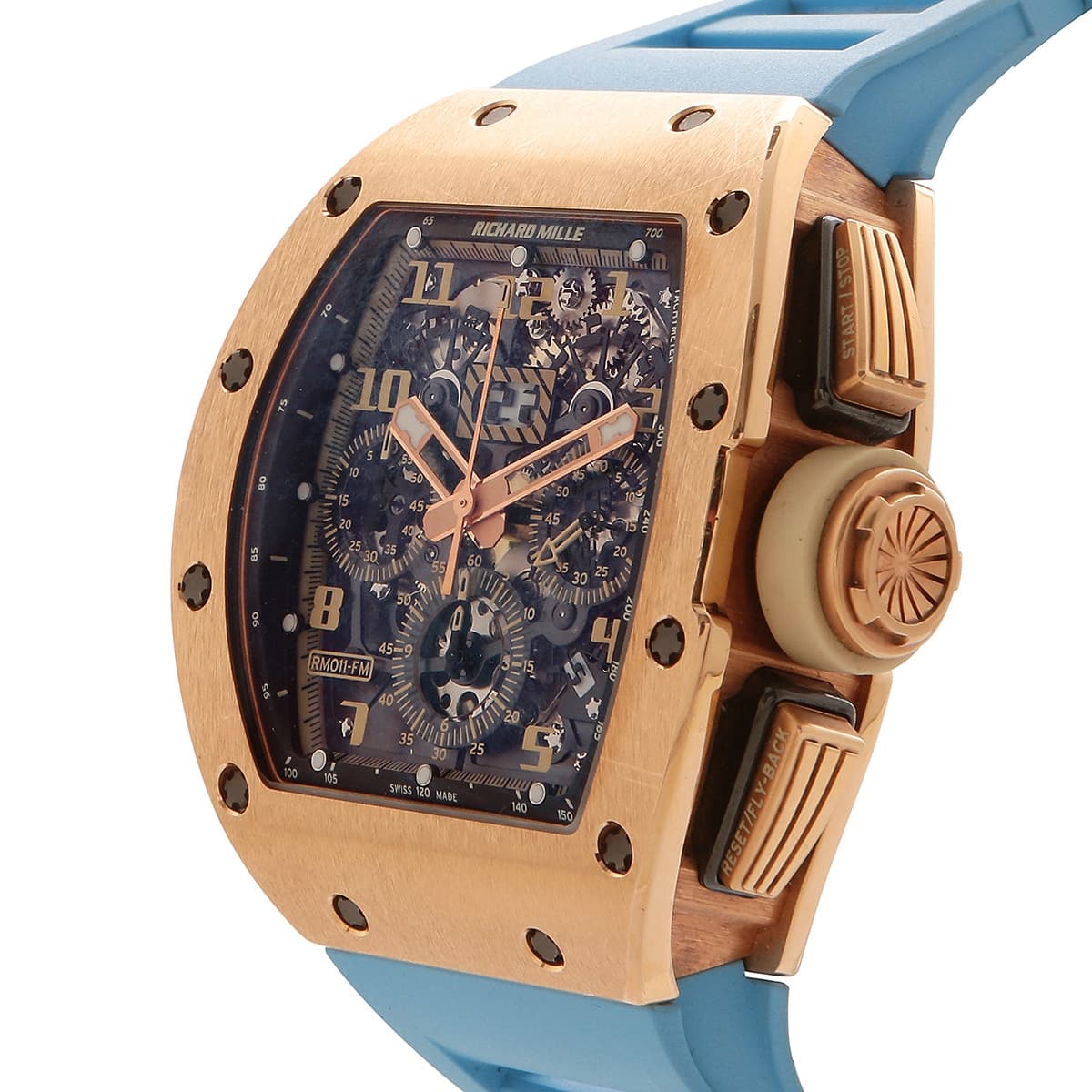 Richard Mille rose gold watch with skeleton dial and light blue rubber strap showing the crown.