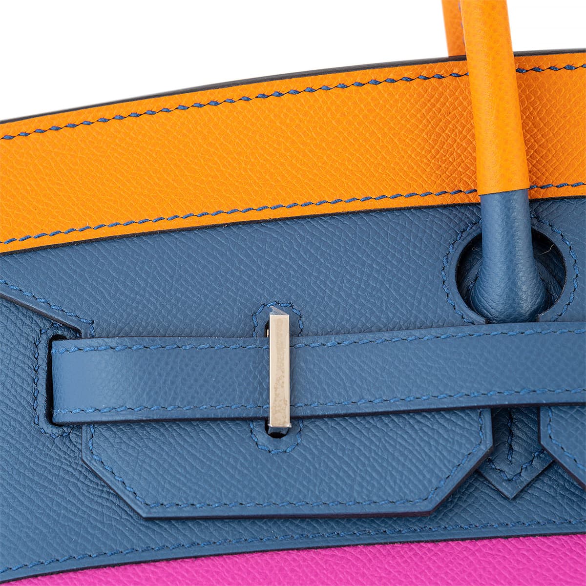 Close up view of the Hermes Birkin 35 bag showing silver pontent , navy sangle with navy stitching.