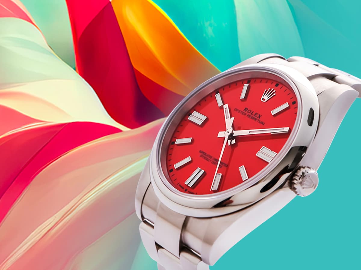 Close up of Rolex Oyster Perpetual stainless steel watch with red dial.