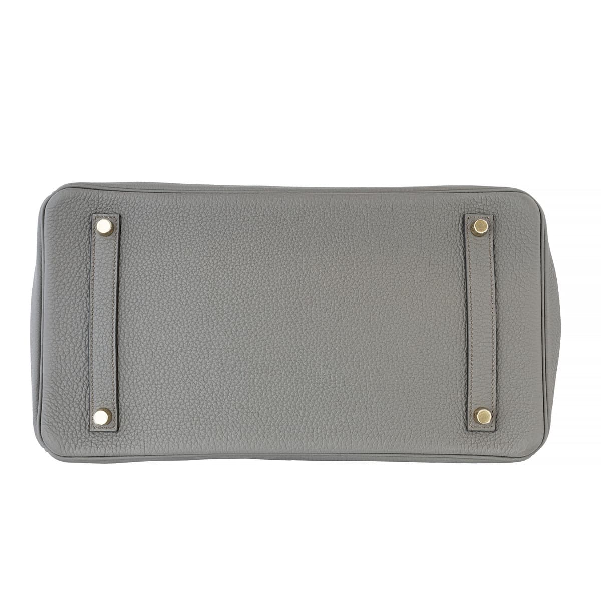 Base of the grey Hermes Birkin 35 showing four silver clous.