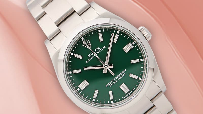 Rolex Oyster Perpetual with green dial and stainless steel bracelet.