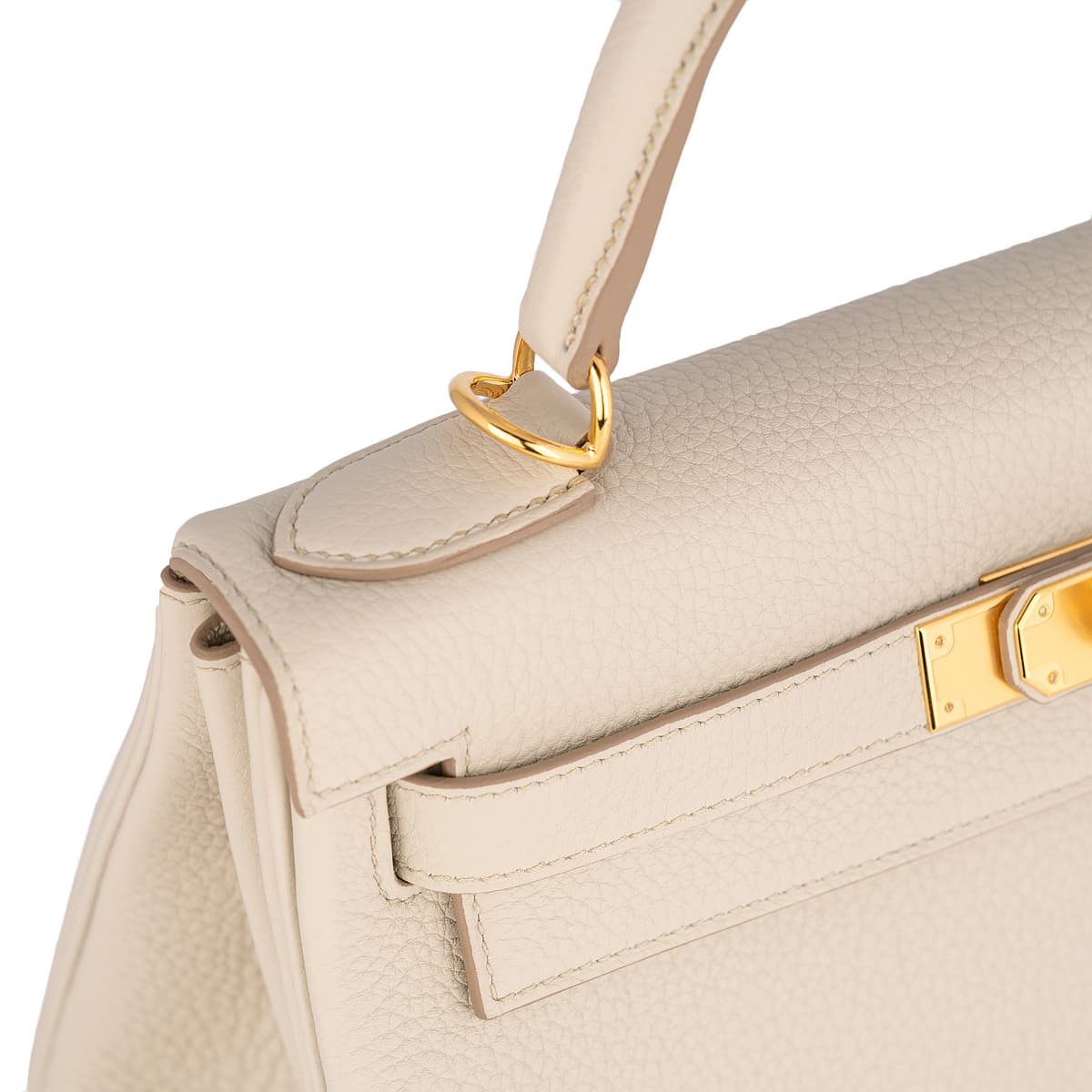 Close up of handle detail on Hermes Kelly 28 Togo in gris perle leather with gold hardware.