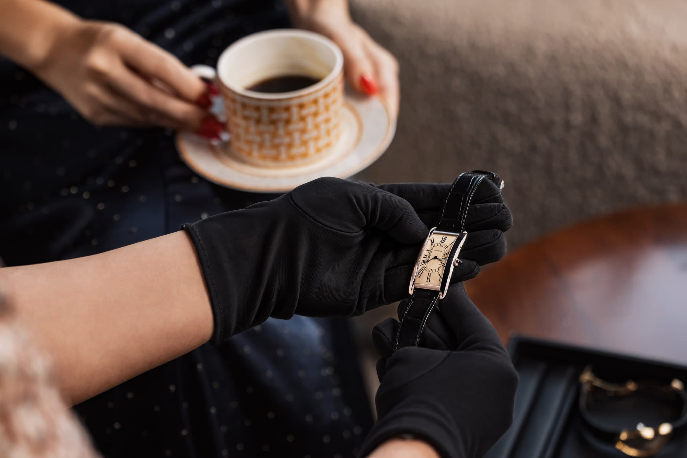 Coffee in the collectors’ lounge while a specialist in white gloves presents a Cartier Tank