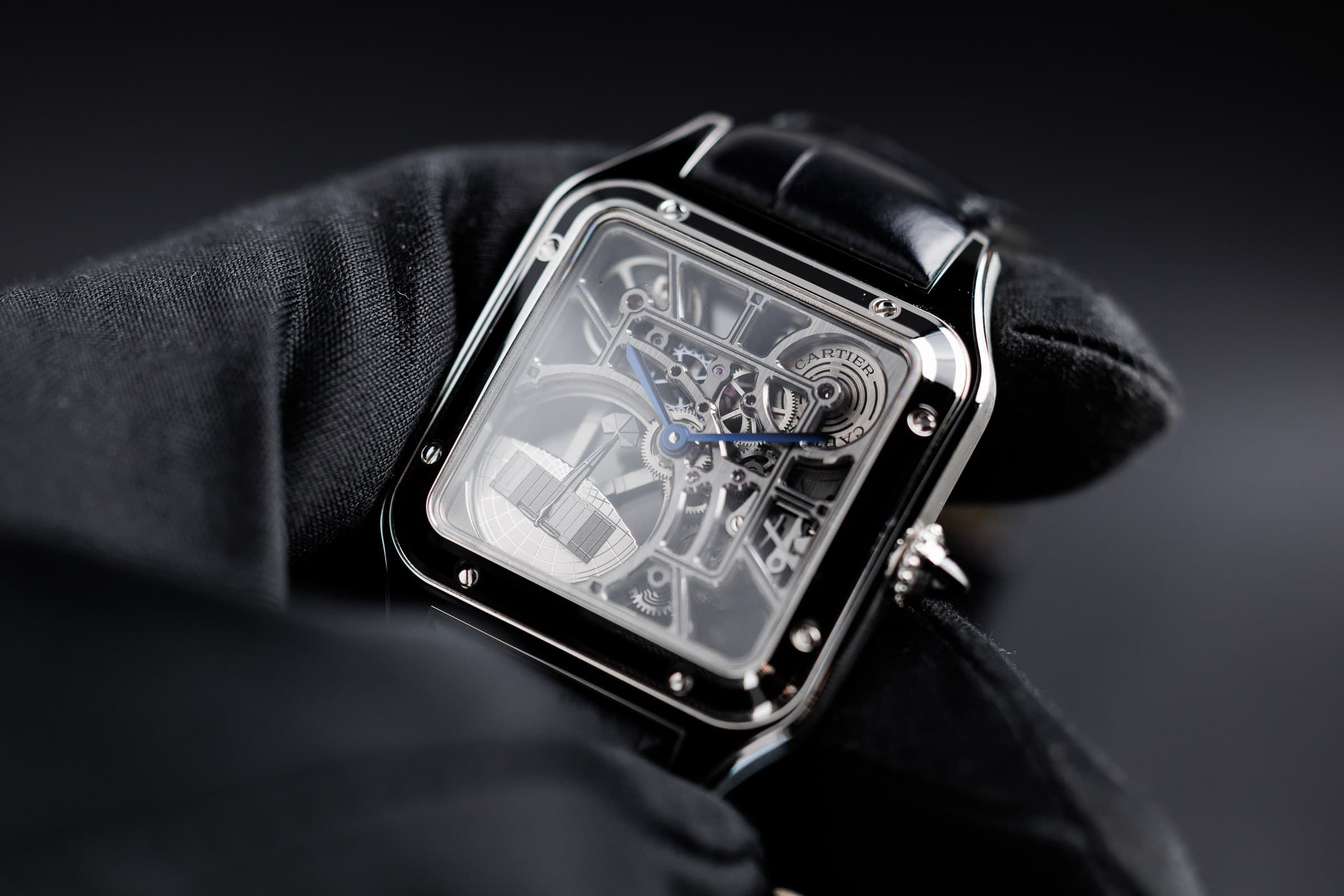 Cartier Santos-Dumont Skeleton WHSA0044 in steel, held in a gloved hand